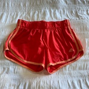 Pink and orange adidas athletic shorts.